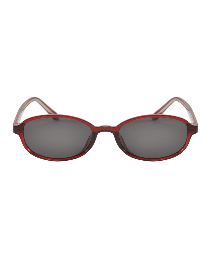 The ESTA GLASSES - RED by TIGERMIST are oval-shaped fashion sunglasses with red plastic frames, dark UV400-protected lenses, shown on a plain white background.