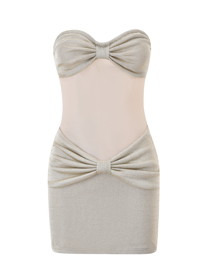 The ESTE MINI DRESS - CHAMPAGNE by TIGERMIST features a strapless sweetheart neckline, metallic knit fabric, sheer mesh midsection, gathered bust and hip with knot accents, and a form-fitting silhouette.