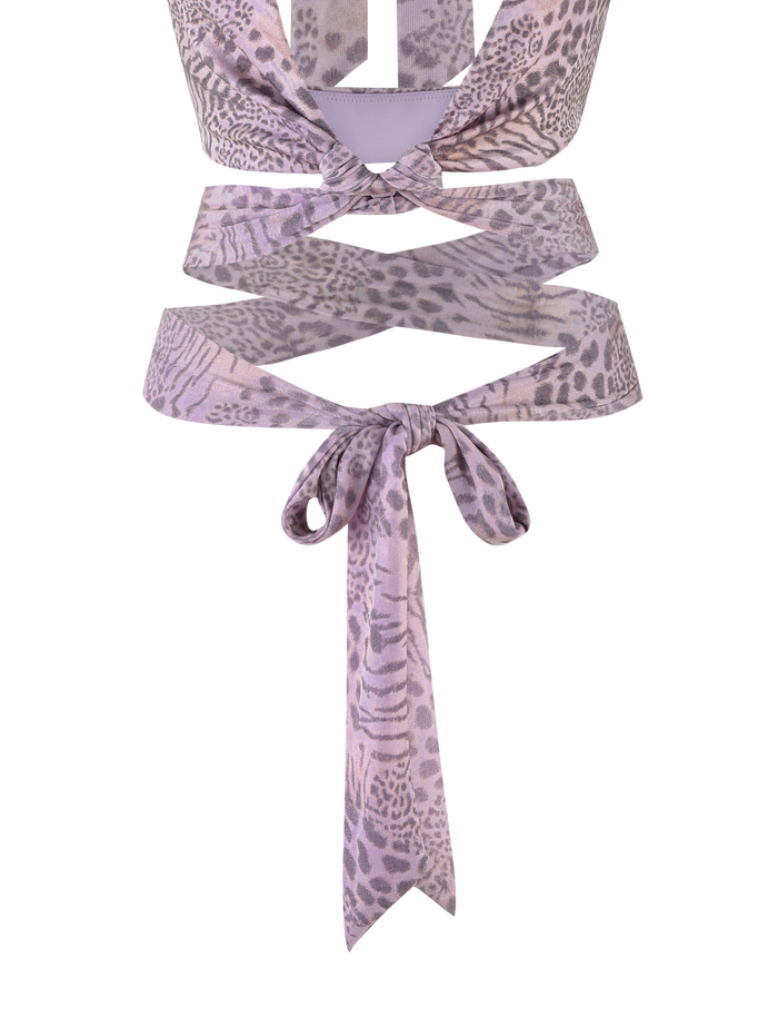 The EVANGELINE TOP by TIGERMIST in Pale Pink Tiger features a light purple and pink tiger print, a back knot, waist cut-outs, and a flattering bodycon fit.