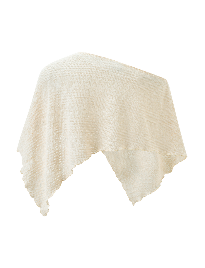 The FAIRLEE PONCHO by TIGERMIST features a cream crochet knit, off-shoulder design with an asymmetrical hem and soft drape, shown against a plain white background.