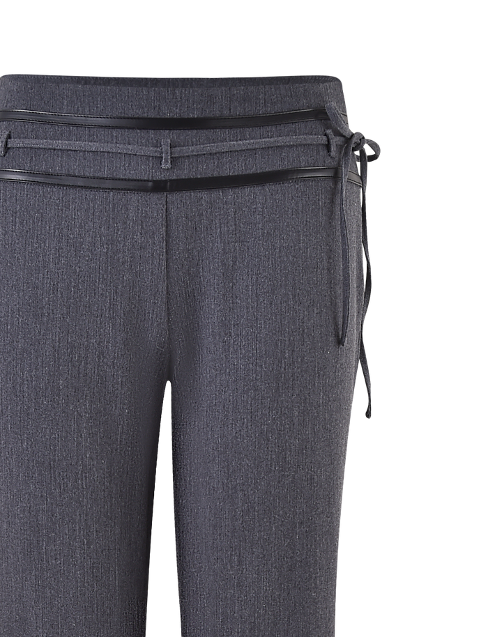 The TIGERMIST FEDRA PANT - GREY is a dark gray, mid-rise tailored pant with subtle texture, slim legs, and a matching knotted belt. The image showcases the waistband and sleek belt detail.