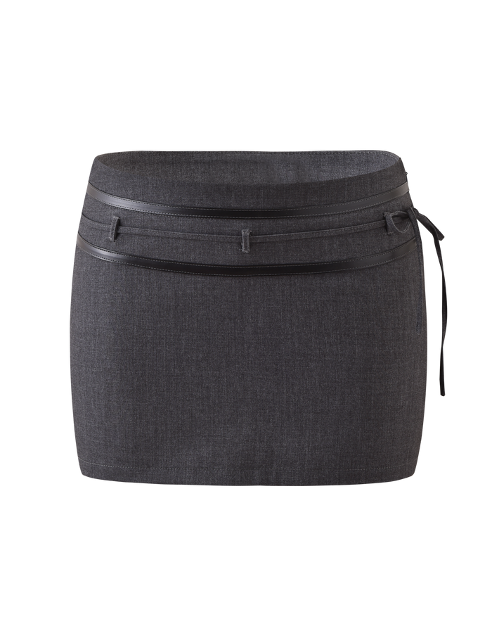 The FEDRA SKORT - GREY by TIGERMIST is a dark grey mini skort with a double waistband, slim belt, tie detail on the right side, and subtle leather accents, shown against a plain white background.