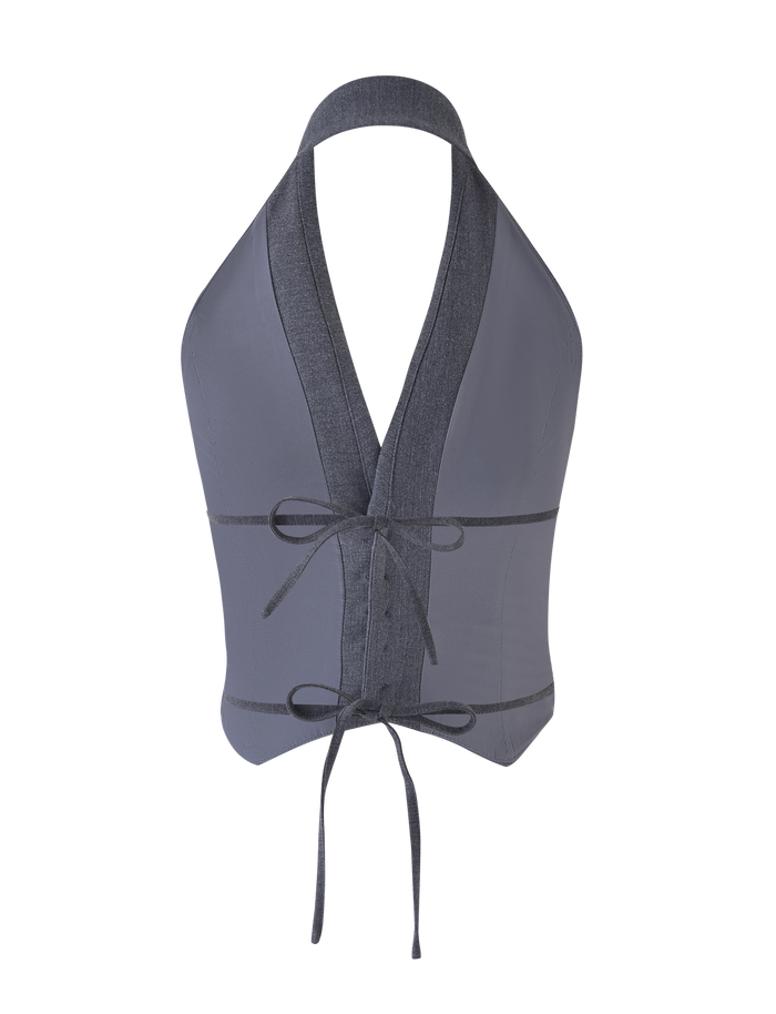 The TIGERMIST FEDRA VEST - GREY is a sleeveless, backless halter vest with a deep V-neck, two front waist ties, and darker gray trim on the neckline and edges. Crafted for a soft feel and tailored fit.