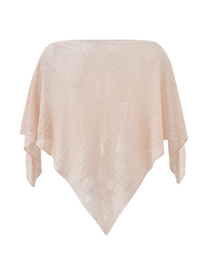The FERN CROCHET PONCHO in Champagne by TIGERMIST features a semi-sheer, textured design with pointed ends, draped in a diamond shape—ideal for festivals or as an elegant beach cover-up.