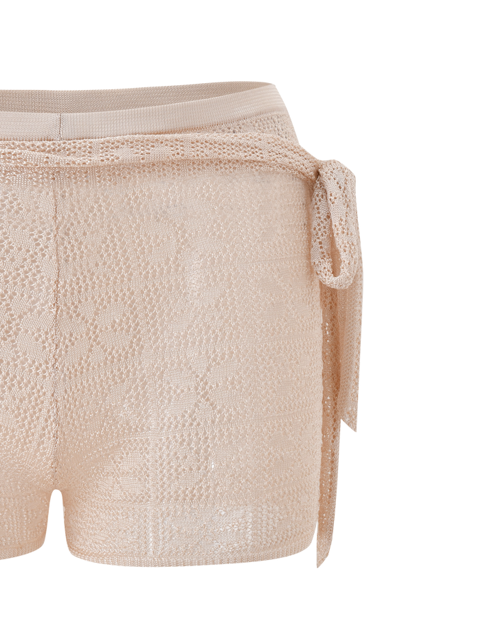 The TIGERMIST FERN CROCHET SHORT in Champagne is a semi-sheer, floral-patterned mini short with a matching crochet tie belt and adjustable waistband, shown on a plain white background.