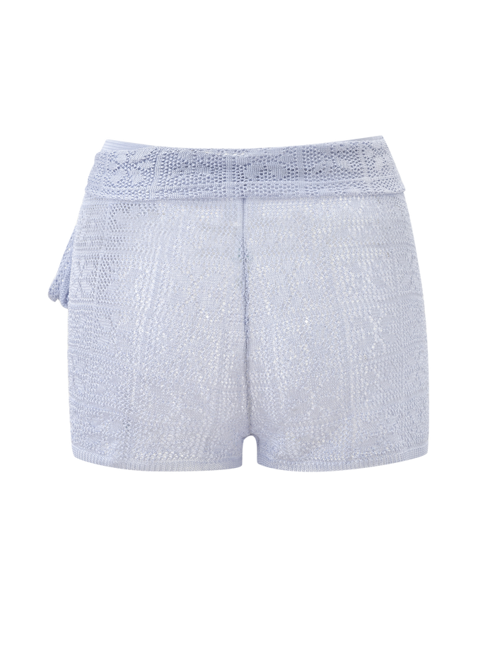 The TIGERMIST FERN CROCHET SHORT - SILVER is a light blue, high-waisted short with a custom crochet design, textured pattern, and an adjustable fabric tie waistband on the left side, shown against a white background.