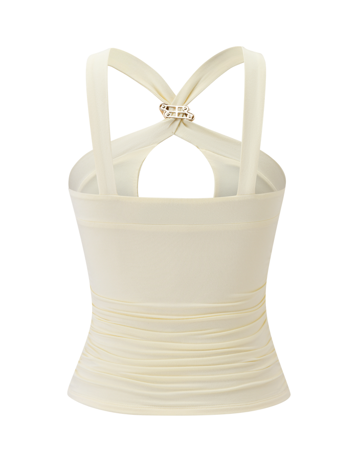 Back view of the TIGERMIST FINCH TOP in cream, showcasing crisscross straps with twisted gold hardware and gentle ruching above the waist for a flattering fit. This sleeveless design creates a chic silhouette.