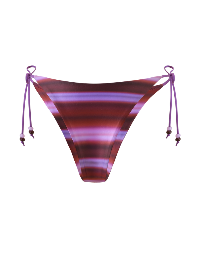 The TIGERMIST FINLEA BIKINI BOTTOM - DUSK OMBRE STRIPE features cheeky coverage, purple side ties with bead accents, and red, pink, and ombre purple stripes, all shown against a plain white background.