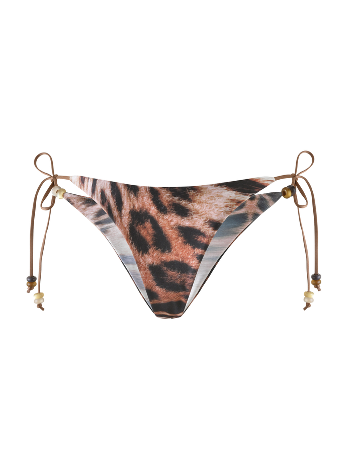 The FINLEA BIKINI BOTTOM in Leopard Haze by TIGERMIST features a cheeky cut, brown side ties with small beads, and is displayed on a white background.