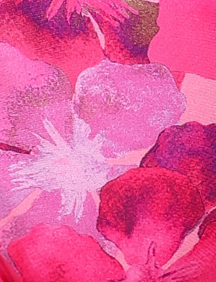 Close-up of the FINLEA BIKINI BOTTOM - PINK : HIBISCUS by TIGERMIST, featuring a vibrant abstract floral print in shades of pink, red, and white that evokes playful summer vibes.