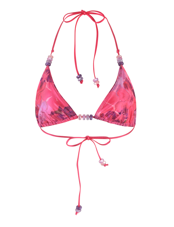 The FINLEA BIKINI TOP - PINK : HIBISCUS by TIGERMIST features a floral triangle design with adjustable halter neck and back tie straps, finished with delicate bead accents.