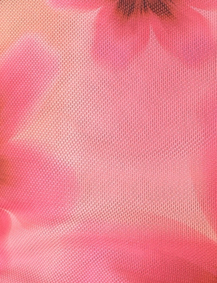 Close-up of the FRANCIS TOP - MULTI : OMBRE : FLORAL by TIGERMIST. This fabric features intricate floral patterns in various shades of pink with slightly transparent mesh sections, offering a smooth and soft appearance—perfect for crafting a stylish floral print top.