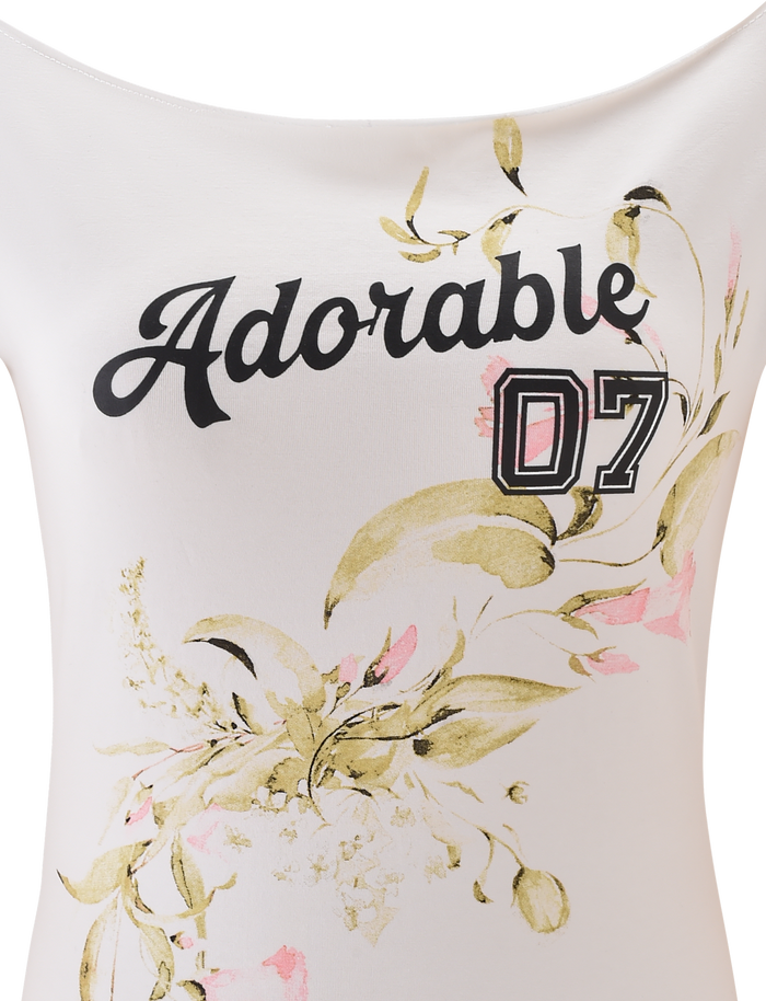The FYNN TEE - WHITE by TIGERMIST is a white baseball tee with “Adorable 07” in black and pink lettering and a soft green and pink floral graphic on the bottom right.