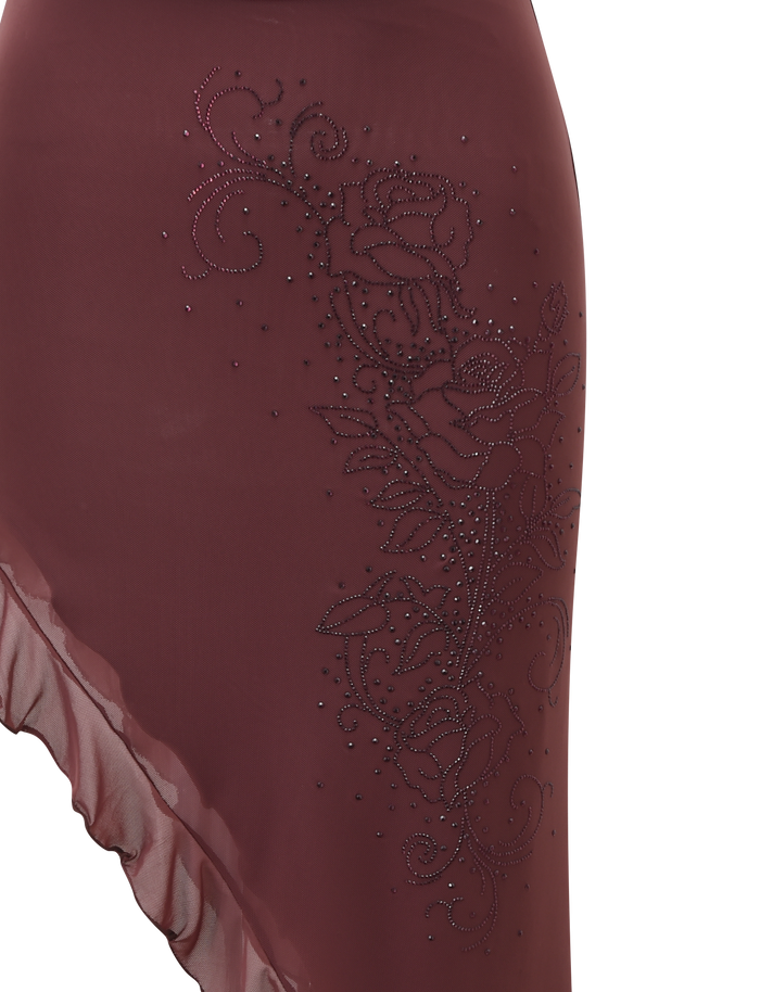 A close-up of the TIGERMIST GEORGIE DIAMANTE HI LO SKIRT in chocolate, showcasing its asymmetrical ruffle hem and sparkling diamante detailing on one side.