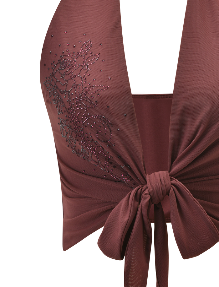 A close-up of the TIGERMIST GEORGIE DIAMANTE TOP in chocolate, featuring a sleeveless, deep v-neck, a tie-front, and rhinestone floral accents on one side.