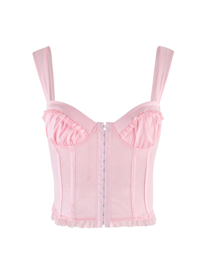 The TIGERMIST GINNY TOP - PINK : BABY PINK is a light pink corset with wide straps, sweetheart neckline, ruffle trim at bust and hem, structured boning, and front hook-and-eye closure, shown on a white background.