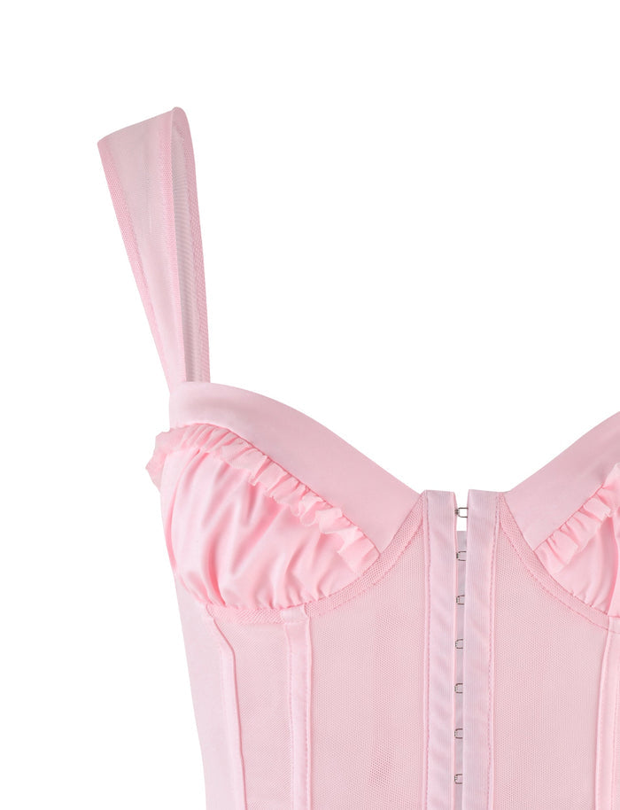 Close-up of the GINNY TOP - PINK : BABY PINK by TIGERMIST, a corset-style top featuring wide straps, ruffled bust detailing, sweetheart neckline, structured seams, and front hook-and-eye closure.