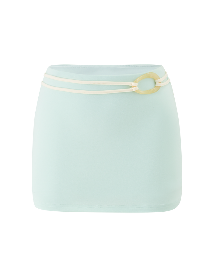 The TIGERMIST GREER MINI SKIRT in mint green is a high-waisted, pull-on mini skirt with a smooth, simple design and a thin cream belt featuring a large oval buckle wrapped twice at the waist.