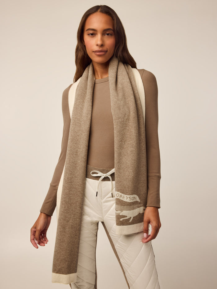 Tan Wool-Cashmere Knit Scarf with Wolf Logo - On-Model Front View, Greyson Wordmark Detail | Greyson Clothiers