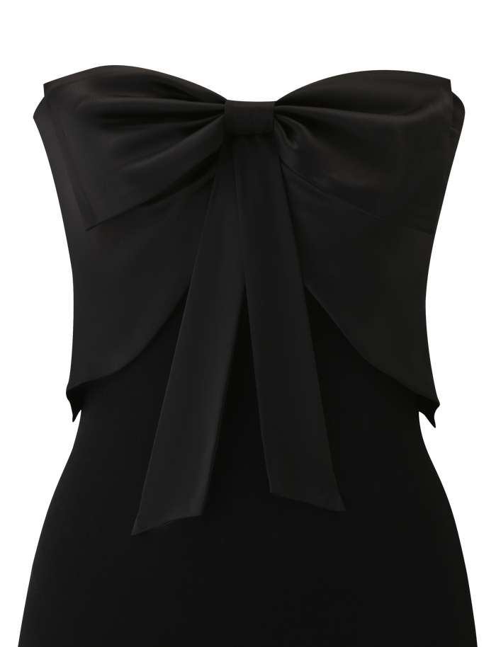 The GROVE MINI DRESS - BLACK by TIGERMIST is a strapless black mini dress with a standout satin chest bow and long ribbon ties draping down the front.