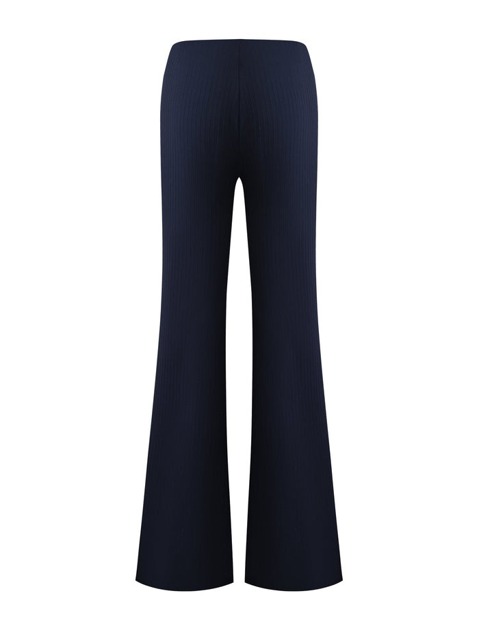 Back view of the TIGERMIST GWENDOLINE PANT in navy, featuring a high-waisted fit, flared legs, and ribbed texture, shown against a plain white background.