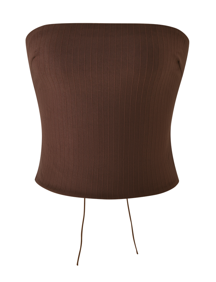 The TIGERMIST GWENDOLINE TOP - CHOCOLATE is a strapless, fitted brown top with a ribbed stripe texture and two thin strings at the hem, shown on a plain white background.