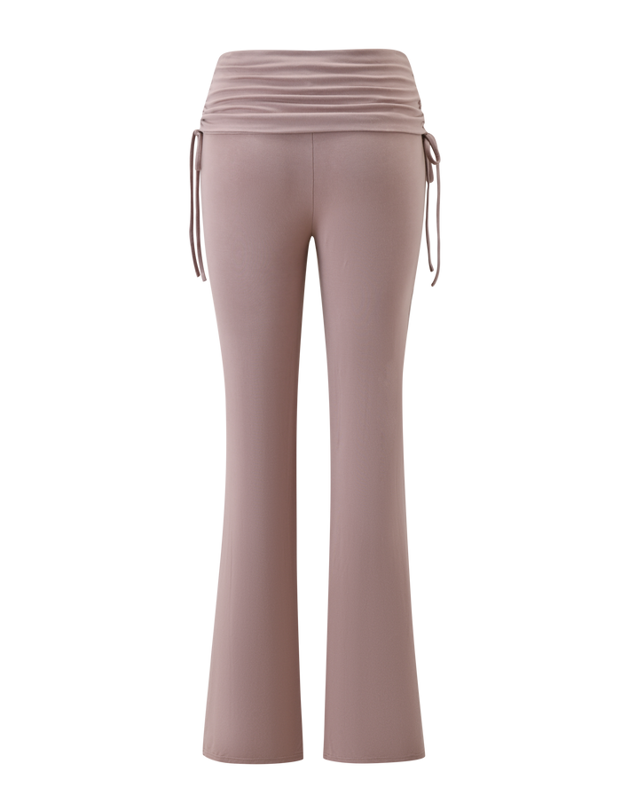 The HALONA PANT - MOCHA by TIGERMIST features high-waisted flare pants with a ruched waistband and adjustable side ties, shown from the back on a white background.