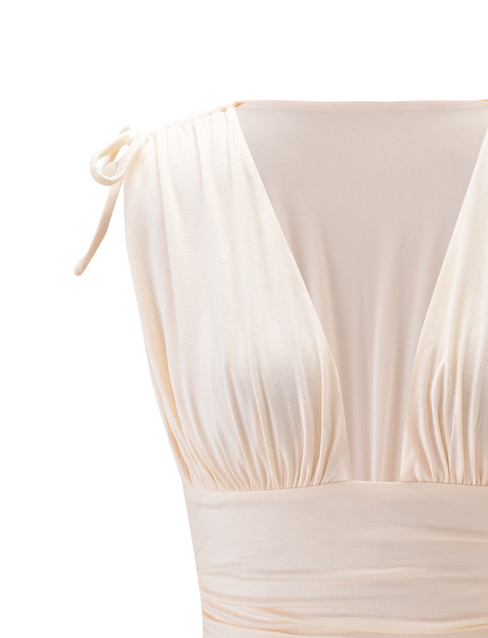 Close-up of the HALONA TOP in cream by TIGERMIST, showcasing a plunging ruched bodice, fitted waist, and adjustable shoulder tie on one side against a plain light background.