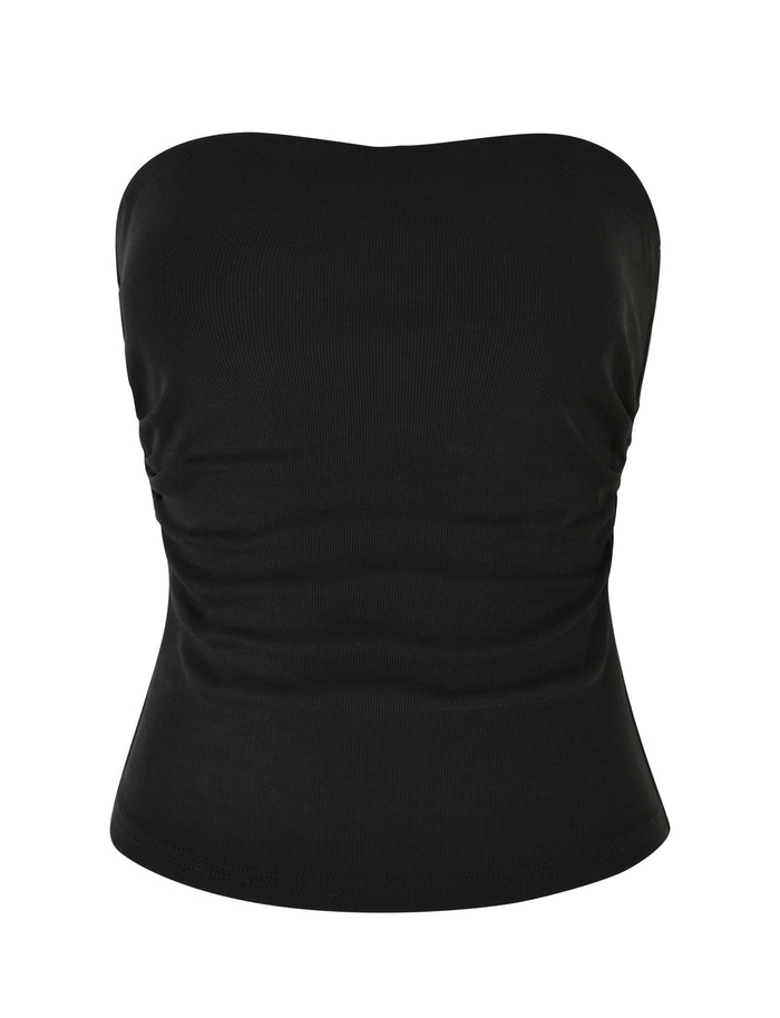 The HARRIETT RIB TUBE TOP in black by TIGERMIST is a strapless top with a form-fitting bodycon silhouette. It features subtle ruching on the sides for a slightly gathered appearance, while the ribbed fabric ensures a snug fit around the chest and midsection, making it both stylish and comfortable.