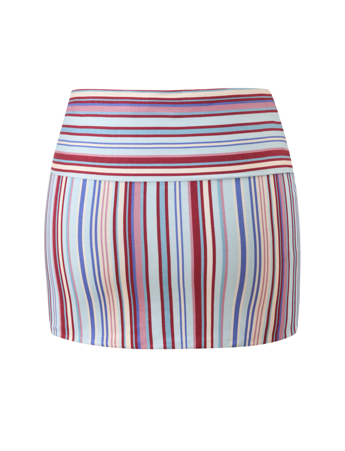 The TIGERMIST HAZE TWIST SKIRT - VARIEGATED STRIPE is a high-waisted, fitted mini skirt with red, blue, white, and beige stripes on a light background for chic standout style.