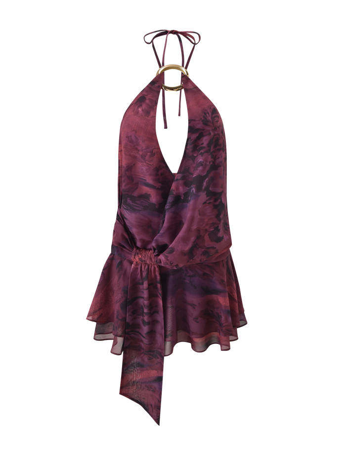 The TIGERMIST INDIGO MINI DRESS 2.0 - BURGUNDY ROMANTICA features a sleeveless halter neck, gold ring detail, gathered waist, and an asymmetrical ruffled micro mini skirt in a maroon and dark purple marble pattern.