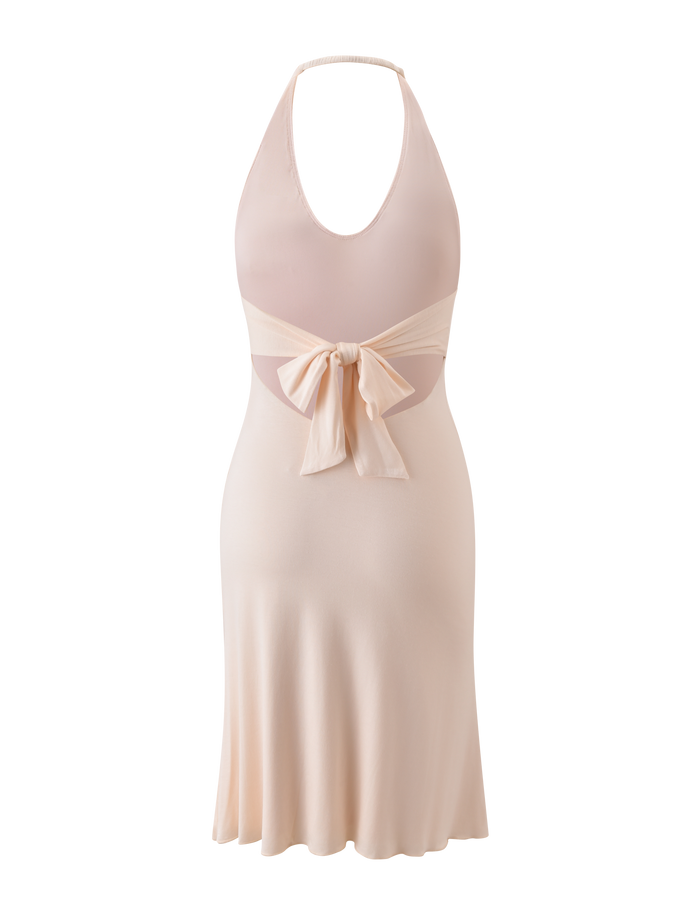 The ISABELLE MIDI DRESS - CREAM by TIGERMIST is a sleeveless, halter neck midi dress with an open back, a statement bow at the waist, and a flowing skirt inspired by Emily Venz.