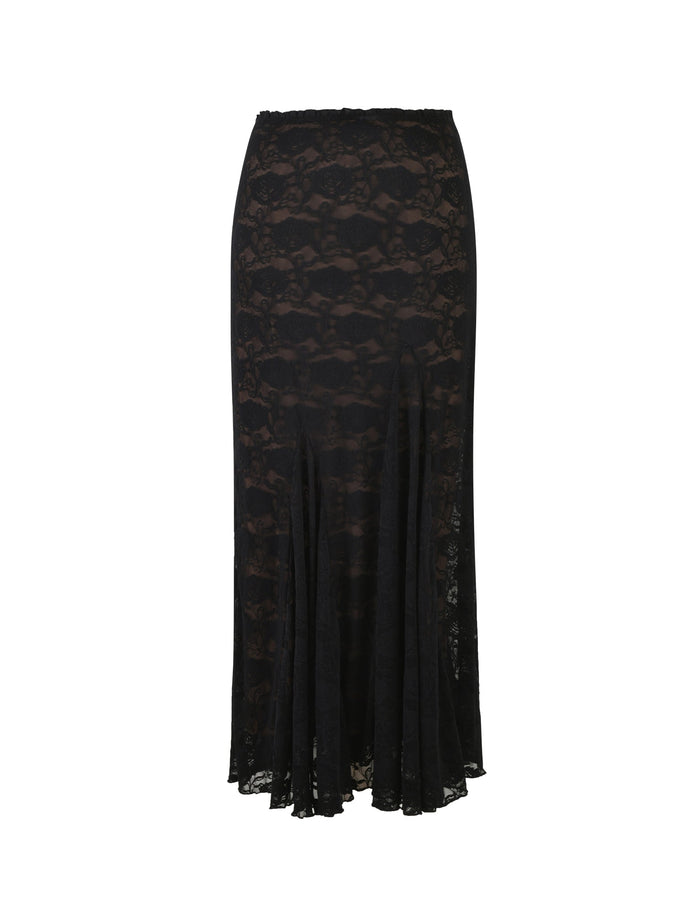 The ISADORA SKIRT - BLACK : LACE from TIGERMIST is a long black lace skirt with a fitted waist and a slight flare toward the hem. The fabric showcases an intricate floral lace pattern, and the hemline falls just above the ankles. This skirt exudes a delicate, elegant appearance.