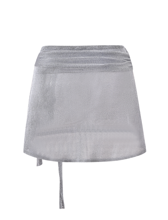 The TIGERMIST ISATANA MINI SKIRT in silver features a sheer metallic knit with mesh texture and an asymmetrical tie detail on the left, shown against a plain white background.