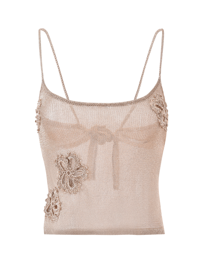 The ISATANA TOP - GOLD by TIGERMIST is a sheer, metallic beige camisole with adjustable straps and see-through fabric, featuring crochet-style floral appliqués on the left side and near the right strap.