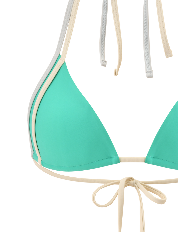 A close-up of the TIGERMIST JACE BIKINI TOP in kelly green with beige trim and straps, featuring an adjustable halter neck and tie-back design, set against a plain white background.