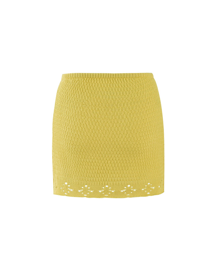 The JANAI SKIRT - YELLOW : LEMON by TIGERMIST is a yellow textured mini skirt that features a subtle woven pattern throughout and a lace hem detail at the bottom, with a fitted, close-to-body design. The skirt is showcased against a plain white background.