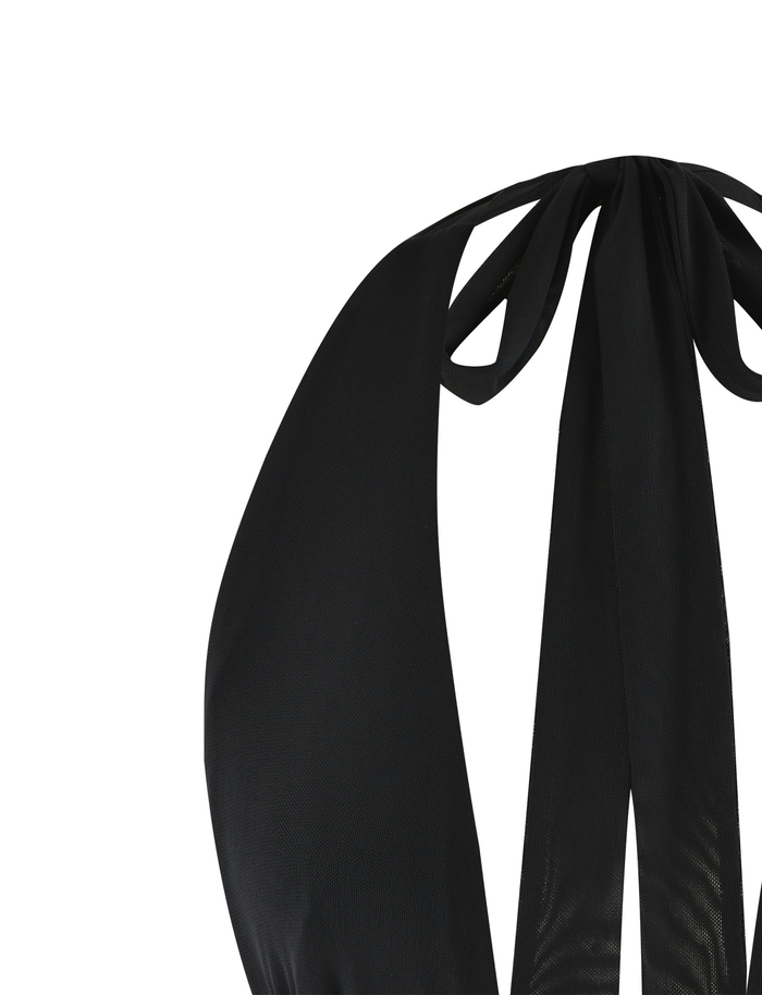 Close-up of the back of the TIGERMIST JANECE TOP in black, showcasing wide straps tied in a bow at the neck and a flattering bodycon fit, set against a white background.