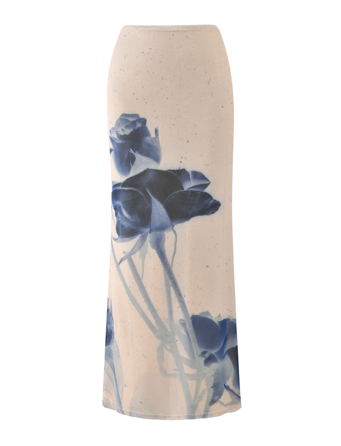 The TIGERMIST JANIS MAXI SKIRT - INDIGO FLORAL is a cream, high-waisted skirt featuring a bold blue rose print on the front.