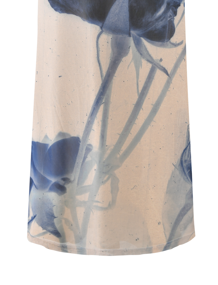 A close-up of the TIGERMIST JANIS MAXI SKIRT - INDIGO FLORAL, showcasing its delicate large floral pattern and soft blue tones.