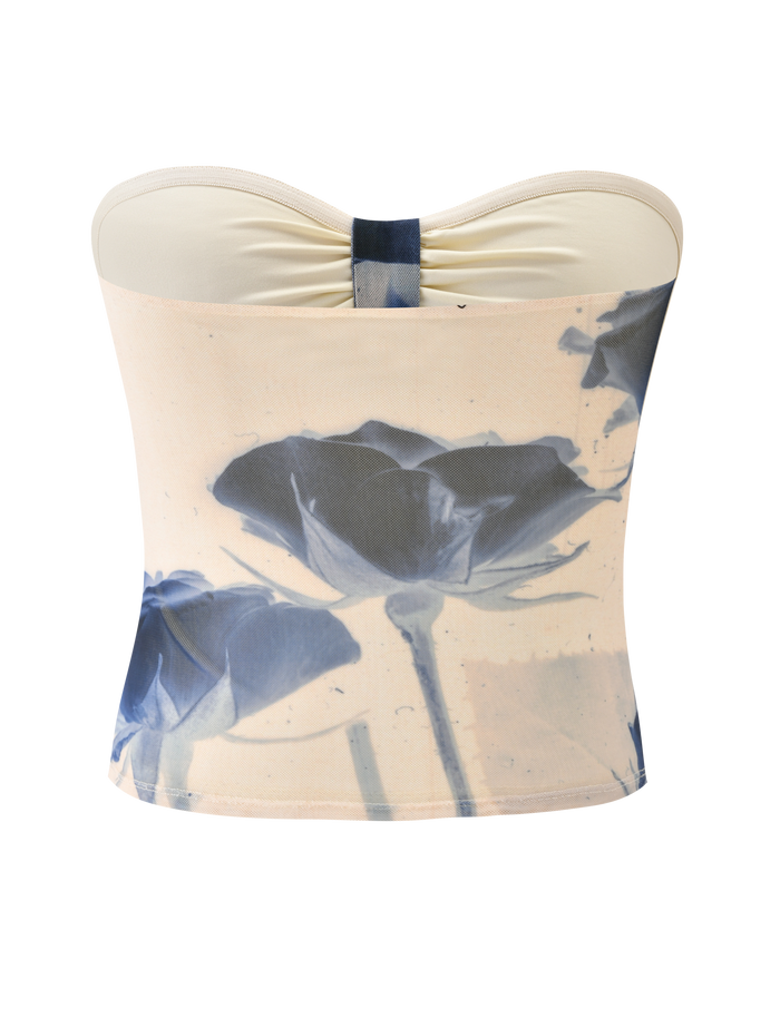 The JANIS TOP - INDIGO FLORAL by TIGERMIST is a strapless sweetheart tube top in a light hue, featuring a blue rose print and center-bust gathering for added charm.