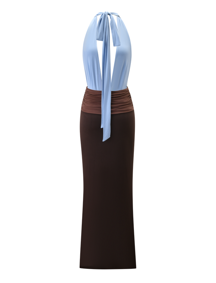 The JENNI PLUNGE MAXI DRESS by TIGERMIST features a sleeveless, colour-blocked design with a light blue halter neck top and long back tie, a brown ruched midsection, and a long, fitted dark brown skirt. The dress is shown on a white background.