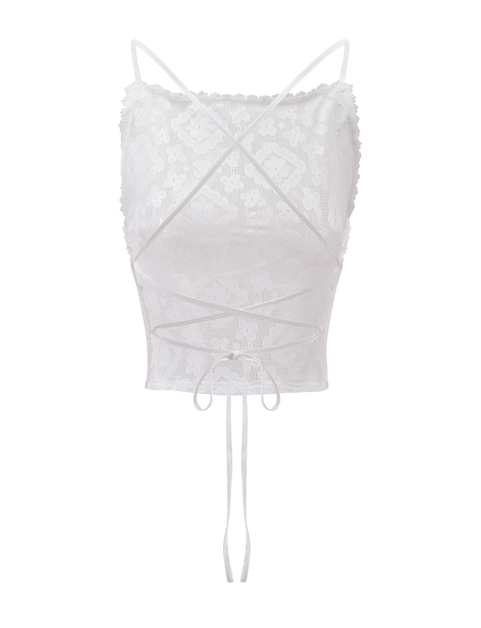 The JESIRA TOP by TIGERMIST is an off-white jacquard lace crop top with spaghetti straps, crisscross front ties, a fitted floral design, and scalloped trim for a feminine touch.