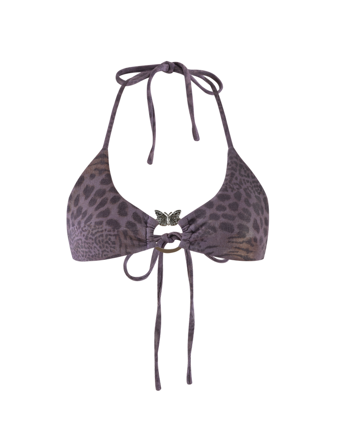 The JESSALYN BIKINI TOP - PURPLE TIGER by TIGERMIST features a purple sparkle animal print, halter neck ties, a silver butterfly pendant at the center, and tie-back strings.