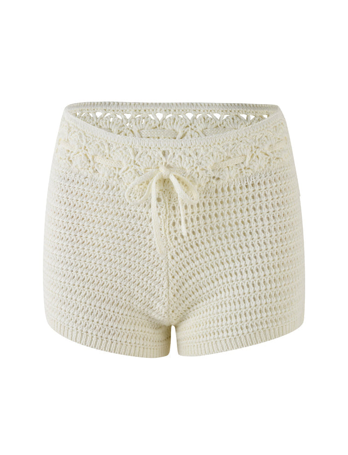 The JONAS SHORT - WHITE : CREAM by TIGERMIST are white crochet shorts featuring a drawstring at the waist, intricate detailing along the waistband and sides, and a high stretch fabric that gives them a textured, knitted appearance. Designed to sit above the hips.