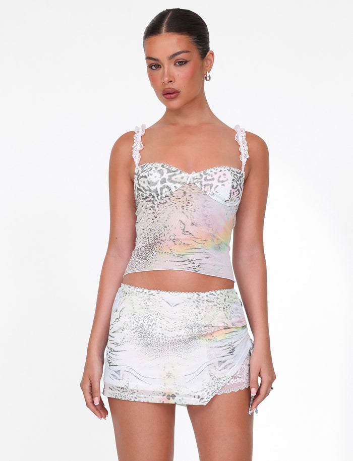 A woman models the TIGERMIST JOSEPHINE TOP in white animal print with lace straps, paired with a matching lace-trim mini skirt, against a plain white background.