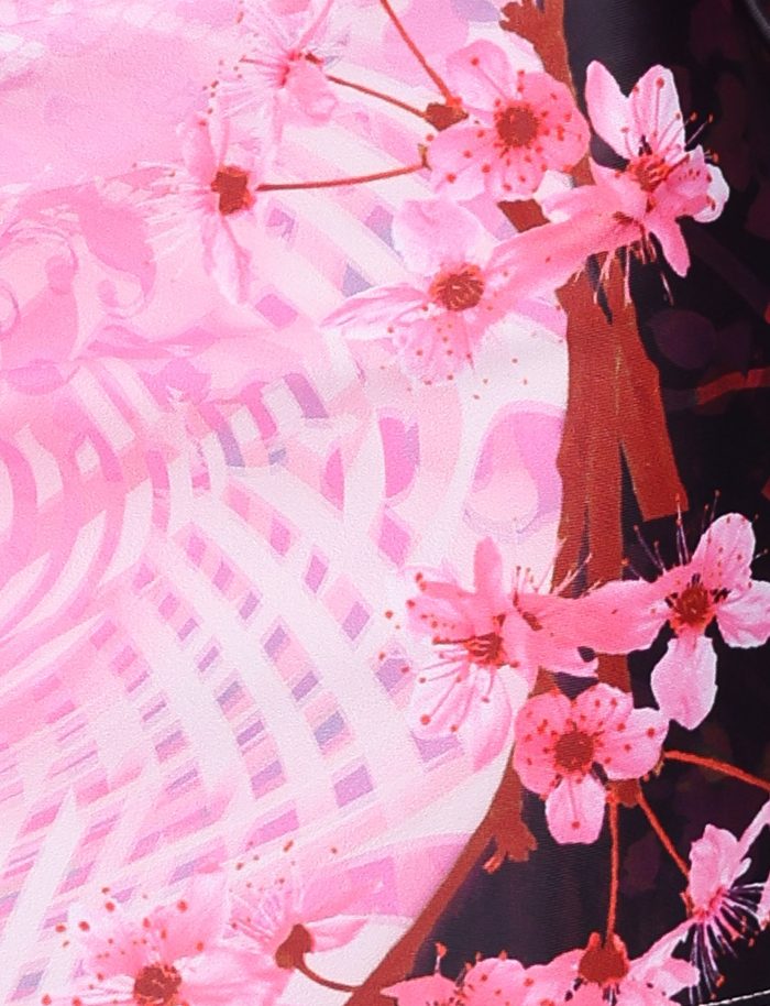 The JOVANNA MINI SKIRT - MULTI: ANIMAL FLORAL BORDER by TIGERMIST features cherry blossom-inspired florals with an abstract pink and white pattern—an eye-catching choice for a breezy, A-line mini skirt.