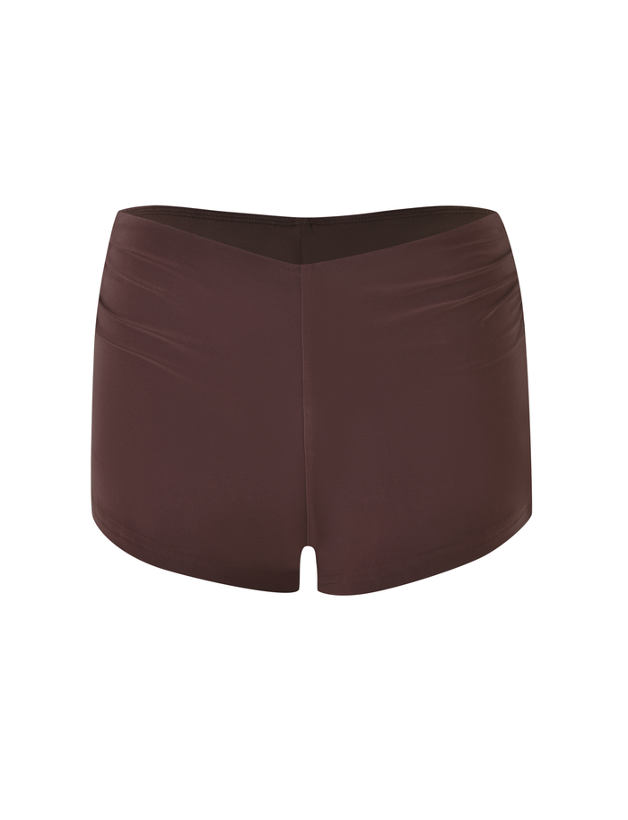 The JOVIENNE SHORT - BROWN: CHOCOLATE by TIGERMIST are high-waisted, fitted women’s swim bottoms in chocolate brown with a seamless finish and subtle ruching, shown against a white background.