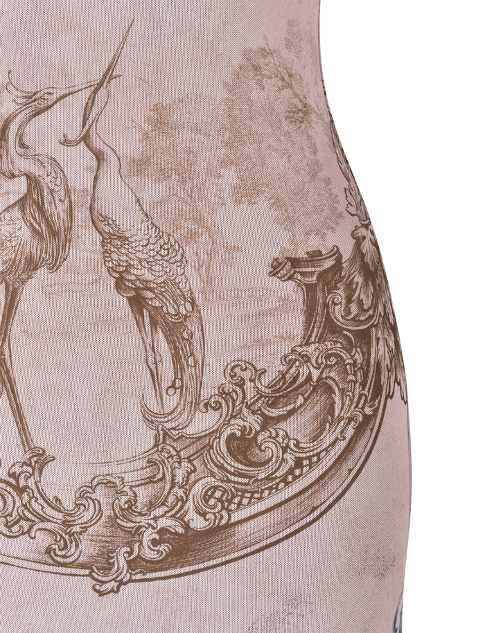A close-up of the TIGERMIST JULIANNA DRESS - MULTI: COLLAGE: CRANES shows an intricate sepia-toned design with two elegant cranes standing on an ornate structure amid foliage.