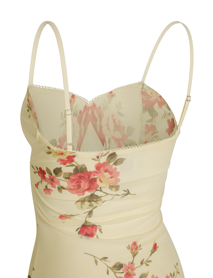 A close-up of the TIGERMIST JULIANNA DRESS in yellow with macro pop floral print, featuring adjustable spaghetti straps and a scalloped neckline for an elegant finish.